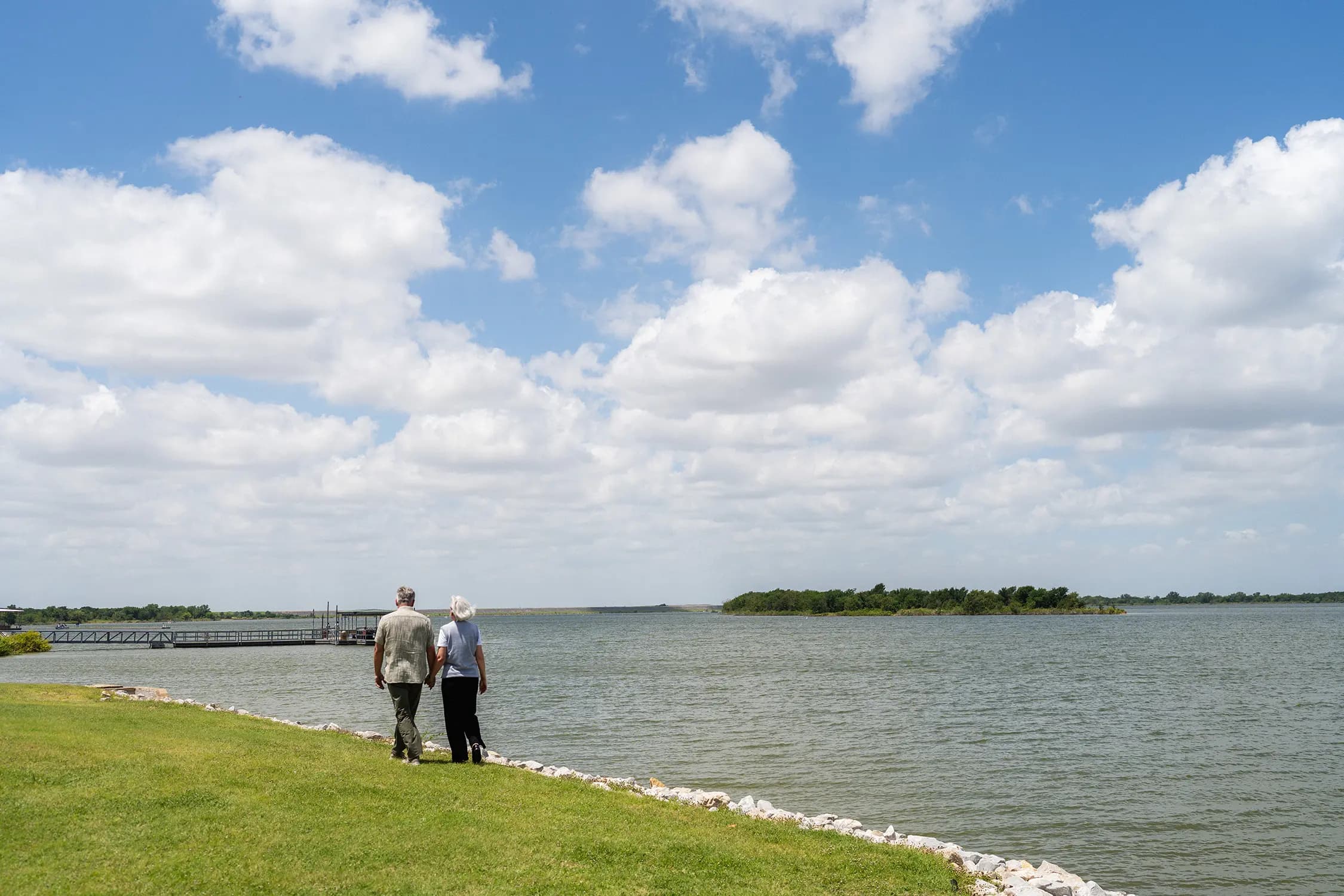 Mark and Kim Shorman walking together by a lake
